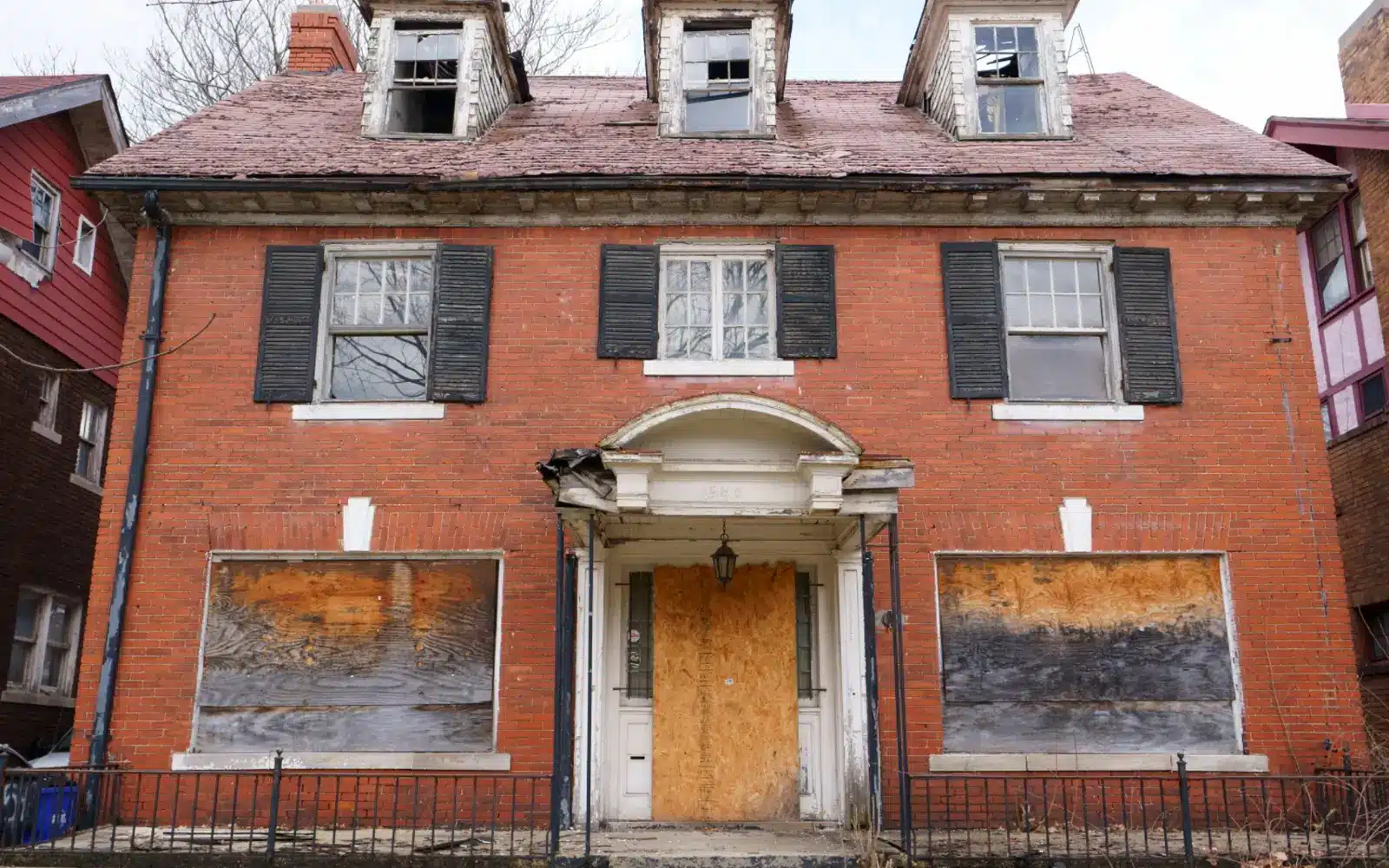An old, boarded-up house highlighting the concept of selling a house as-is for cash, ideal for homeowners looking for quick and hassle-free real estate solutions