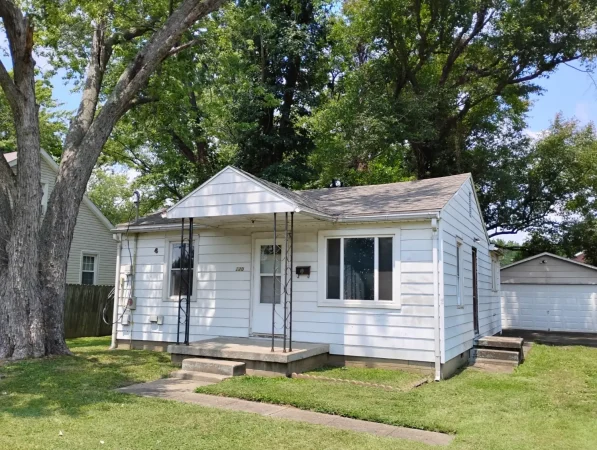 Cozy suburban house with large trees outside